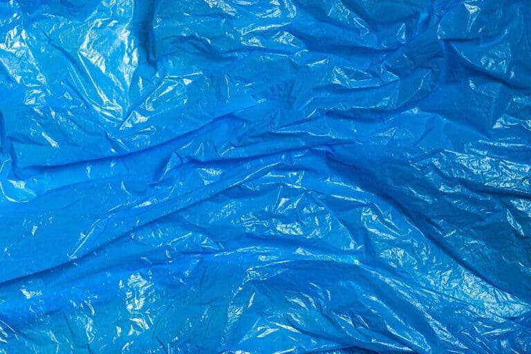 Surface of blue wrinkled plastic bag