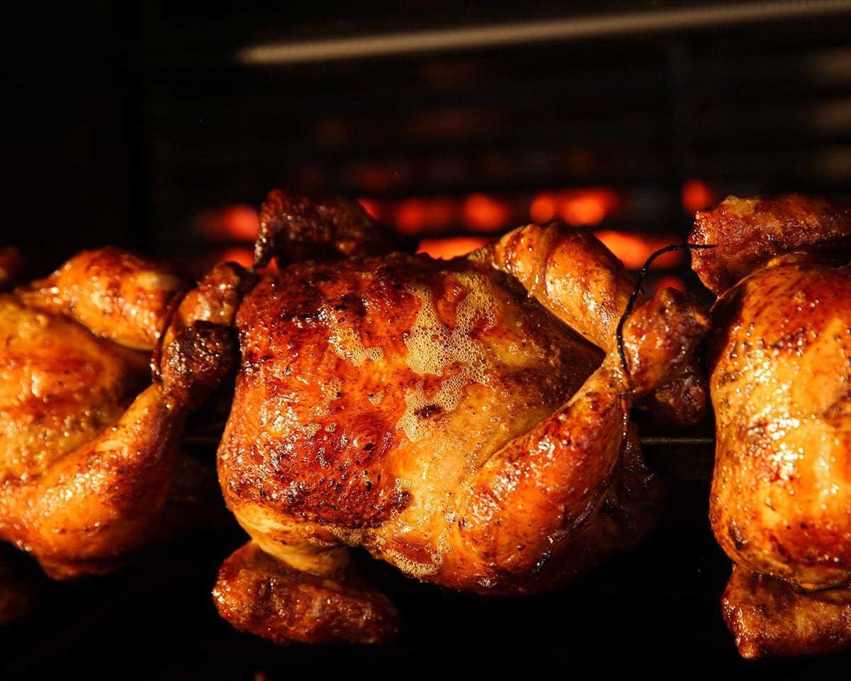 Grilling whole chickens in rotisserie machine