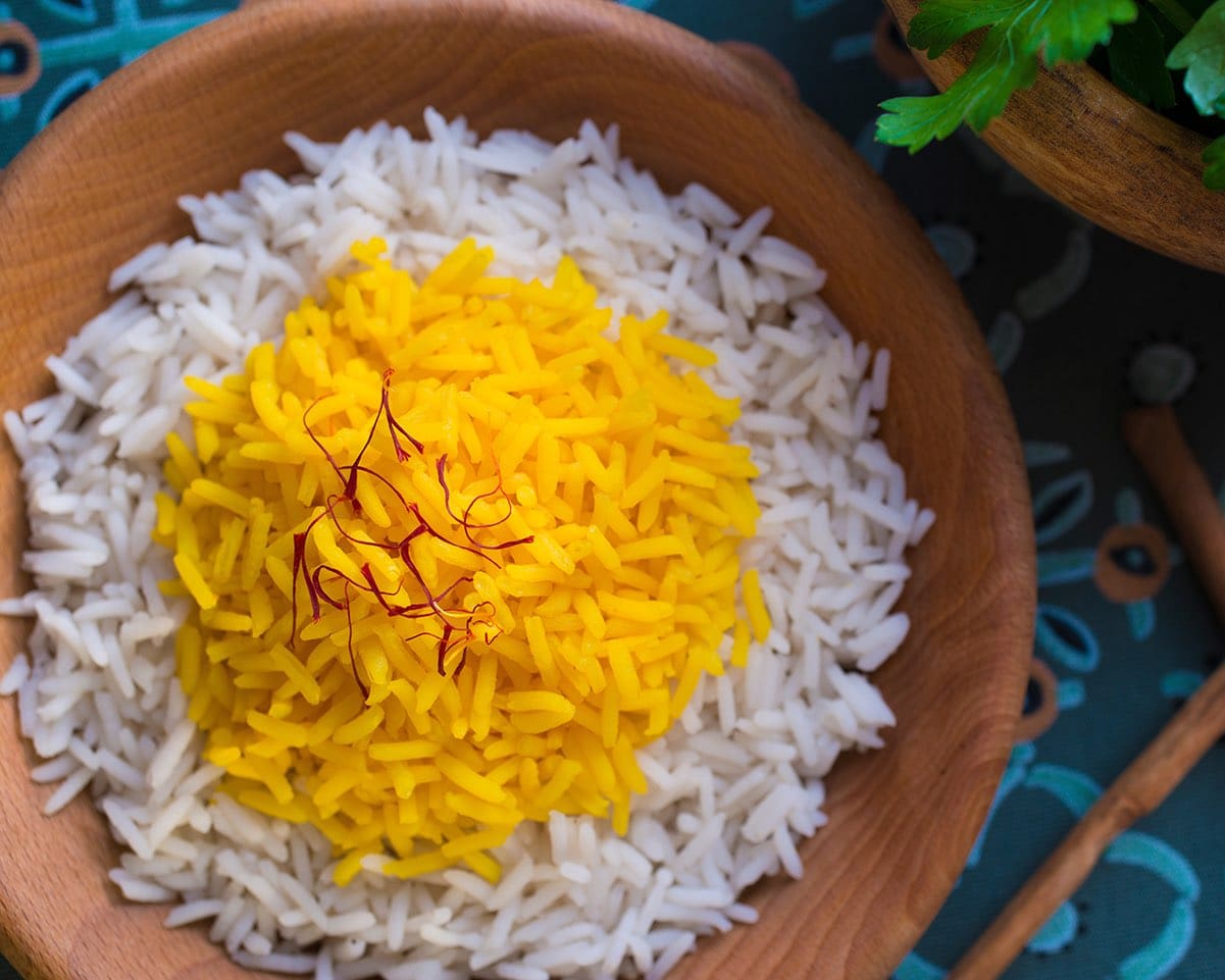 Rice cooked with saffron in a wooden bowl