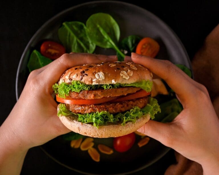 Close-up hands holding vegan burger