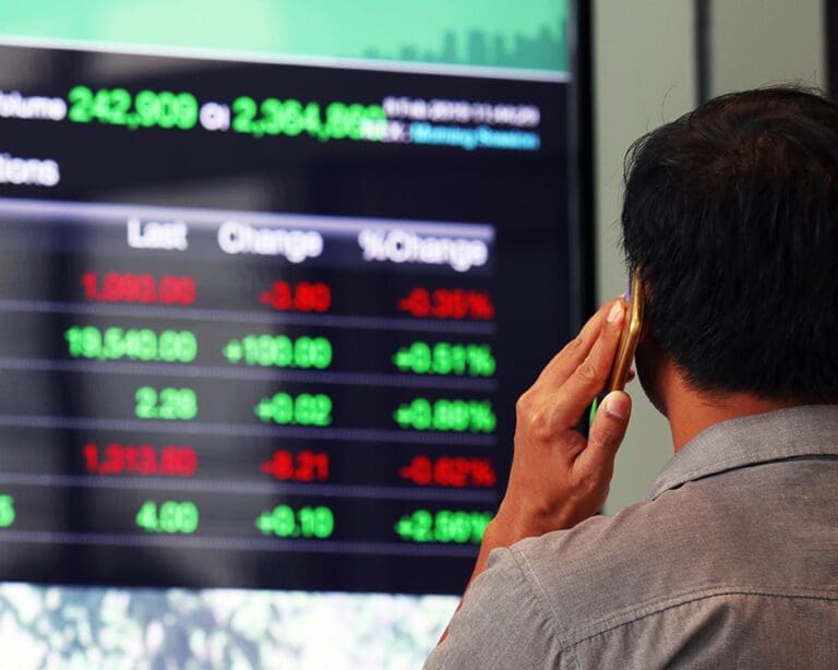 Businessman looking at a stock market board