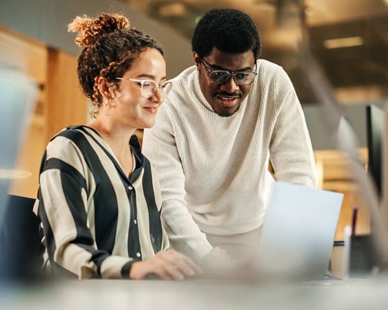 Portrait of two colleagues using a laptop