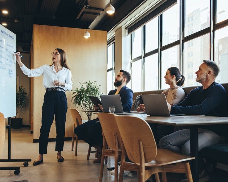 Businesswoman giving a presentation to colleagues during a meeting