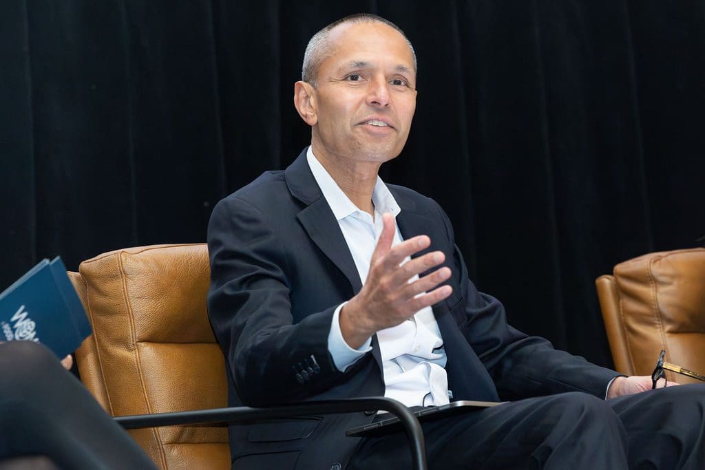 Speaker sitting on stage at a conference