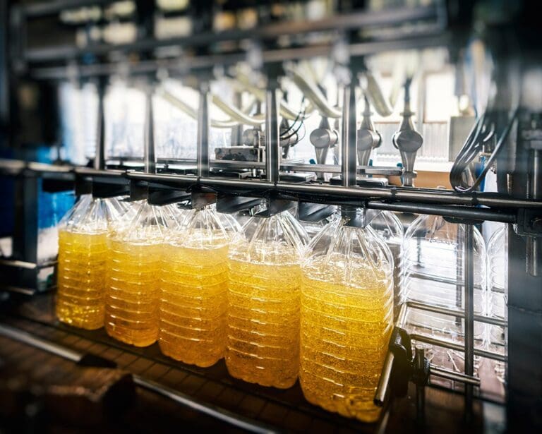 Vegetable oil in plastic containers on a conveyor